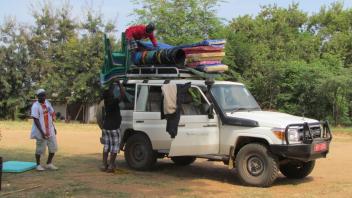 Off-road car packed with supplies on roof