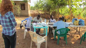 People sorting samples at an outdoor table