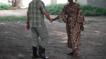 Anton shakes hands with a local woman