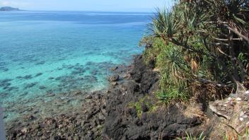 Blue water by a hill