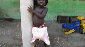 Young girl outside one of the houses in Eticoga.
