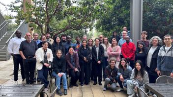 Group photo in front of green trees
