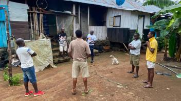 João and Lodney conduct community engagement before the March MRR in Santo Antonio, Príncipe