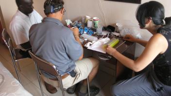 Back at hotel in Bissau sorting and storing mosquitoes collected in Antula. Jao, Anton & Yoosook.