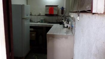 A mall laboratory space with a fridge and a microscope
