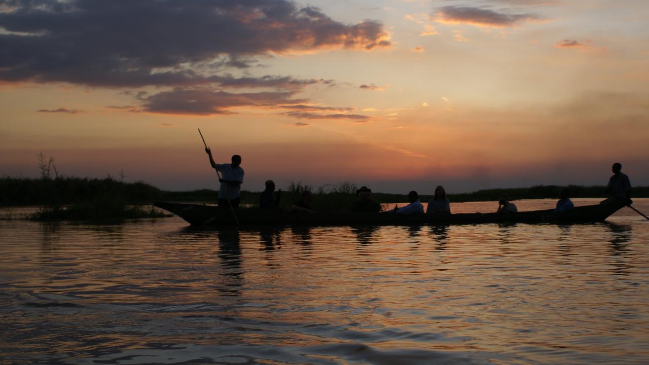 Boat on water at sunset
