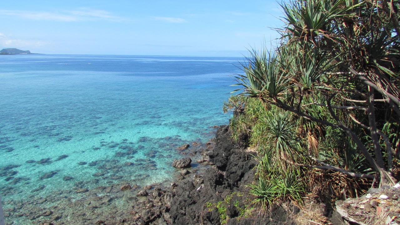 Blue water by a hill