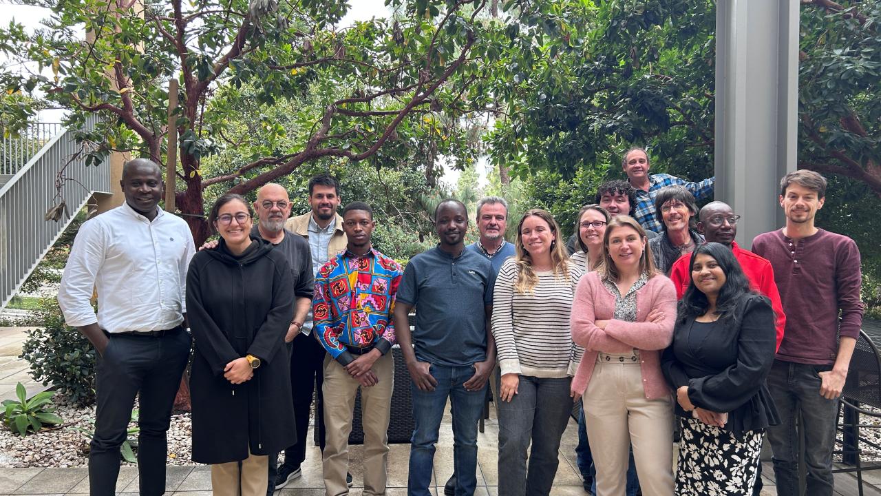 Group photo in front of green trees
