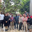 Group photo in front of green trees